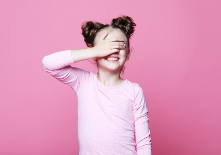 emotion, childhood and people concept: cute smiling girl with closed eyesの写真素材