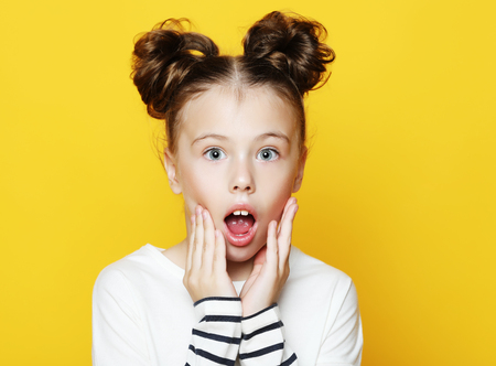 Portrait of little girl  with opened mouth and crazy expression.の写真素材
