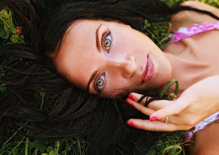young smiling woman on the grassの写真素材