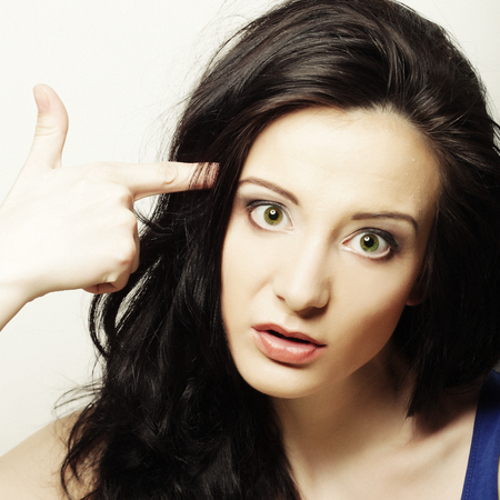 Woman shows gesture gun with fingerの写真素材