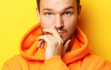 Portrait of a handsome young man, fashion model. Posing over yelの写真素材