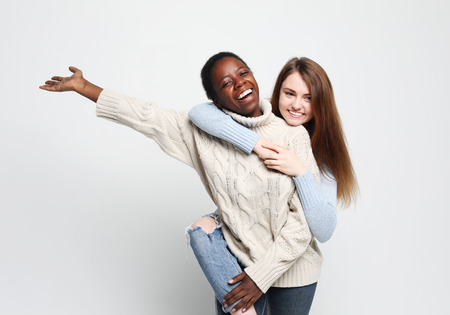 Multiethnic friendship concept. Cheerful European and African women.の写真素材