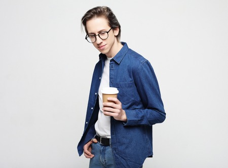 Hipster man standing with takeaway coffee