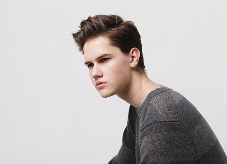 Attractive teenage boy posing in studioの写真素材