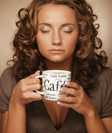 lifestyle, food and people concept: young pretty woman drinking coffeeの写真素材