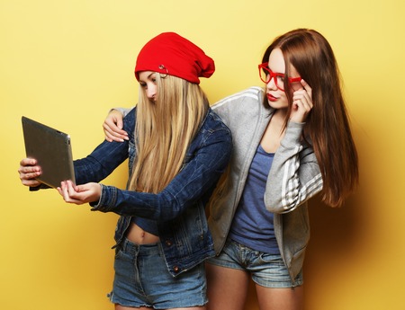 two hipster girls friends taking selfie with digital tabletの写真素材