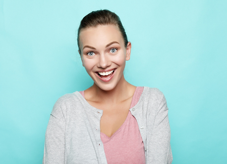 Portrait of beautiful cheerful girl smiling laughing looking at cameraの写真素材