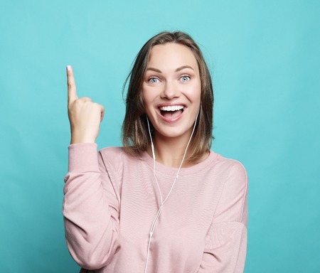 Surprised funny woman showing empty copy space with her finge