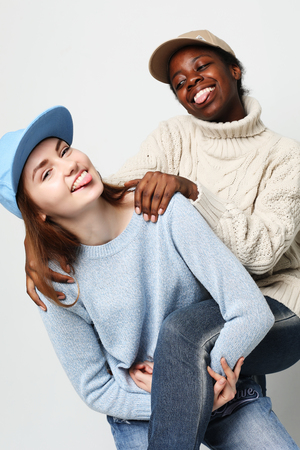 Multiethnic friendship concept. Cheerful European and African women.の写真素材