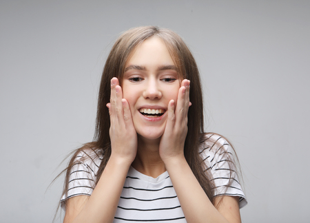 Beautiful girl surprised and shocked looks on you.の写真素材