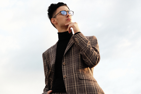 Elegant young handsome man. Outdoors fashion portrait.の写真素材