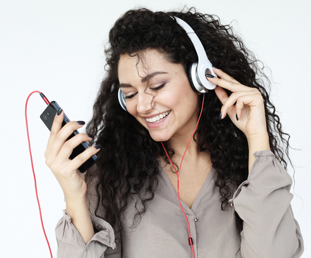 Beautiful African American women listen to musicの写真素材