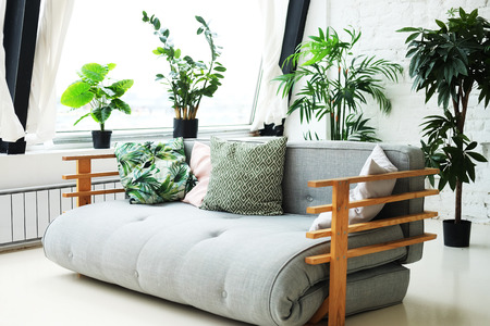 sofa in the room next to the flowers