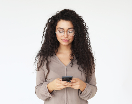 young african woman holds modern cell phoneの写真素材