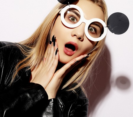 Attractive surprised young woman wearing creative sunglasses, beの写真素材