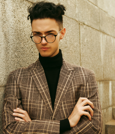 Elegant young handsome man. Outdoors fashion portrait.の写真素材