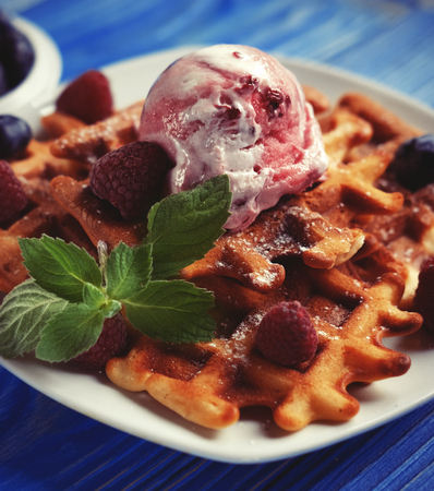 Belgian waffles with fresh berries and ice creamの写真素材