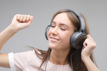 young woman in headphones listening to musicの写真素材