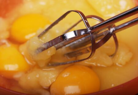 Eggs and sugar in mixing bowl prepare for bakeの写真素材