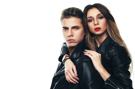 beautiful young couple posing and hugging on a white background, passion and tenderness, fashionable conceptの写真素材