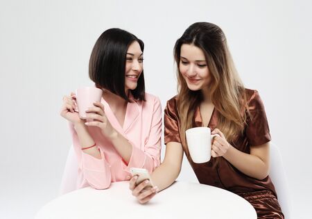 happy friends or teenage girls with smartphone taking selfie and drinking coffee over white...