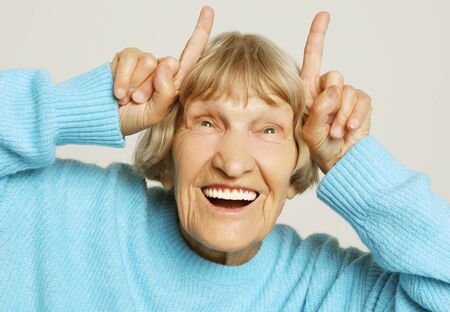 Grey haired old nice beautiful laughing woman. Isolated over white background.