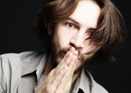 lifestyle and people concept:young man has excited expression, dresssed casually
