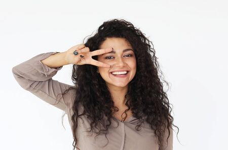Joyful young brunette female show victory sing, lifestyle and emotion concept