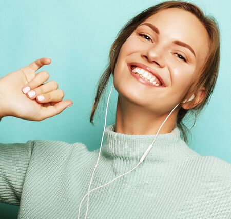 Beautiful young woman in headphones listening to musicの写真素材