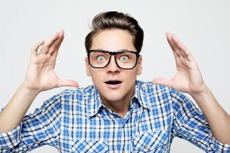 Astonished young crazy man feels stress.