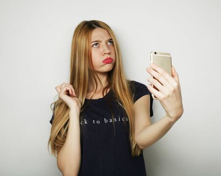 Pretty young woman taking selfie.