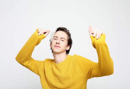 Stylish fashionable young man dancing to the musicの写真素材