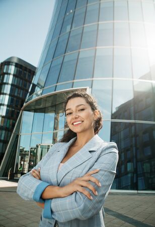 Young african american woman near modern business center, summer day, business conceptの写真素材