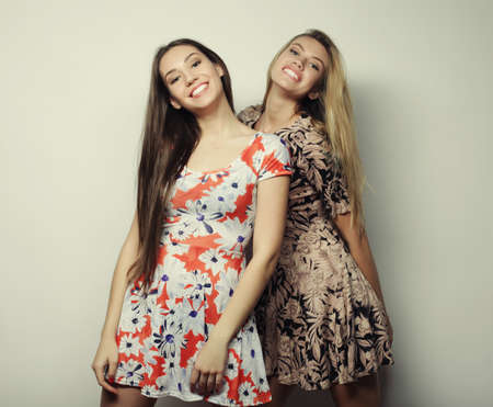 fashion and people concept - two stylish sexy girls best friends wearing dressの写真素材
