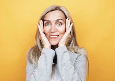 lifestyle, emotion and people concept: Grey haired old nice beautiful laughing woman. Isolated over white background.の写真素材