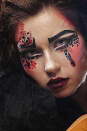 close up portrait young woman with bright make up, halloween theme.