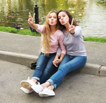 lifestyle, family and people concept - Mother With Adult Daughter In Park Together