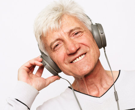 grandpa with headphones listening to the radioの写真素材