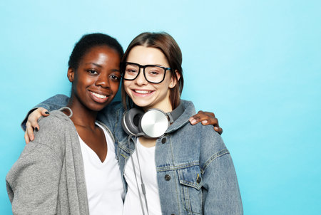 Shot of happy interracial homosexual couple hugging.African-American girl and her charming Caucasian girlfriend.の写真素材