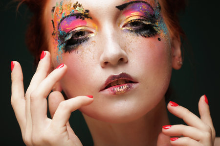 Portrait of young redhair woman with artistic make-up, close up. Beauty concept.