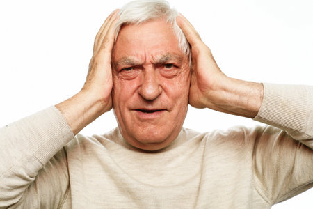 lifestyle, health and old people concept: Senior man wearing casual has headache, picture over white backgroundの写真素材