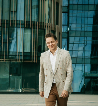 Business, people and lifestyle concept: Young and successful. Handsome young businessman while...