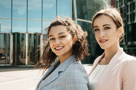Business, people and lifestyle concept: Closeup portrait, two office workers standing together...