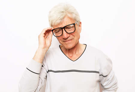 Healthcare, pain, stress, age and people concept - senior handsome gray-haired man wearing eyewear...