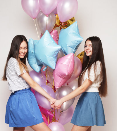 lifestyle, people, teens and friendship concept - Beautiful teenagers female with air balloons on white backgroundの写真素材
