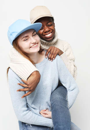 Shot of happy interracial homosexual couple hugging.African-American girl and her charming Caucasian...