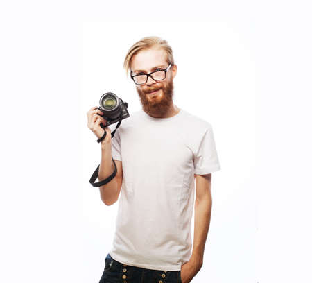 Portrait of a smiling handsome man holding camera isolated on a white background