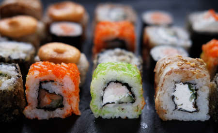 Overhead japanese sushi food. Maki ands rolls with tuna, salmon, shrimp, crab and avocado.