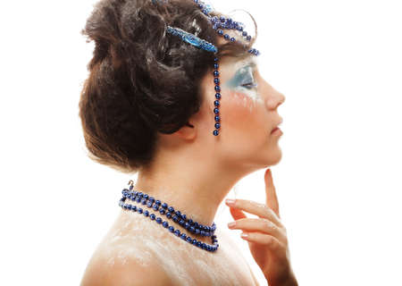 Portrait of a winter lady with creative visage over white background. Blue tones. Beauty concept.の写真素材