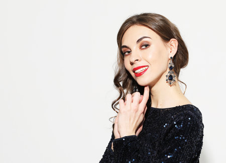 Elegant caucasian brunette woman with curly hairstyle. Charming birthday girl in sparkle dress...